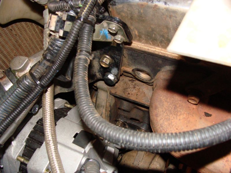 Spacer washers hiding between lower shiny bolt and engine block...