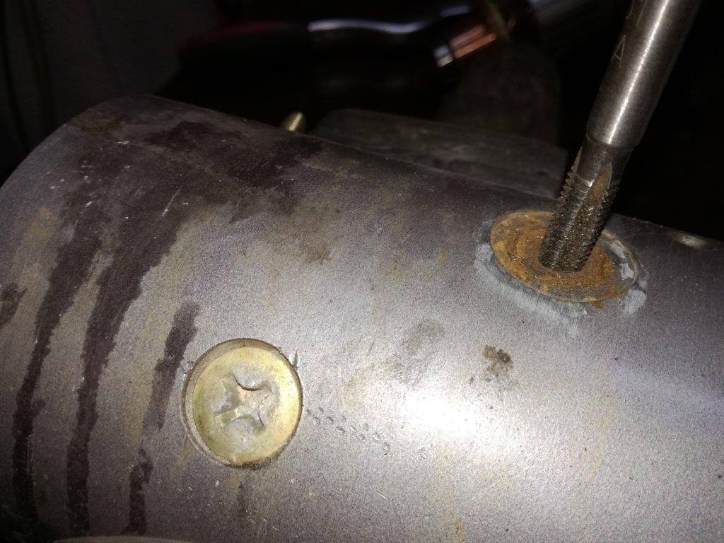 13 re-tapping earth bolt hole.jpg