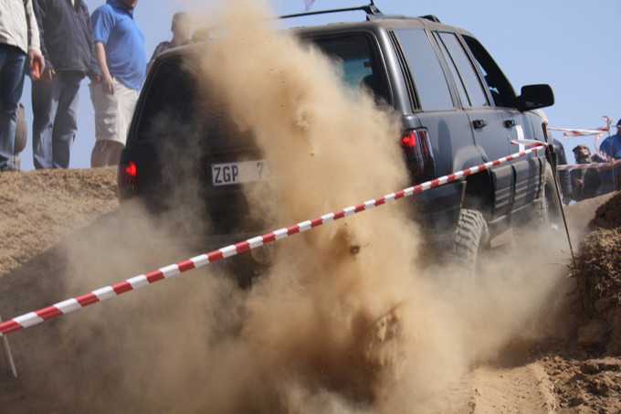 A hearse kicking up dust