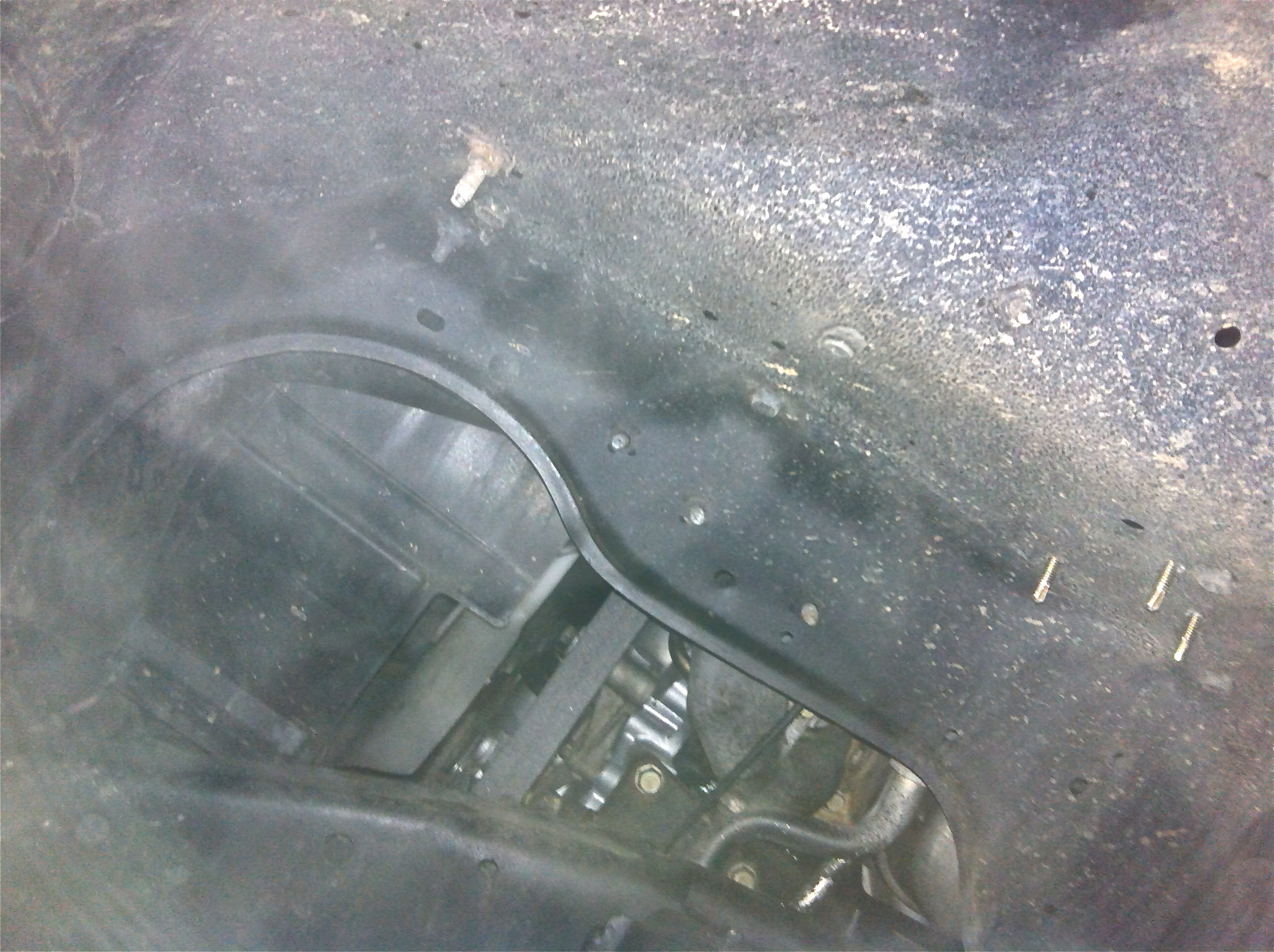 One of the two front tyre-wells, that are missing the debri skirts. Probably important to keep out stones &amp; muck from getting into the moving parts of the engine &amp; pulleys??