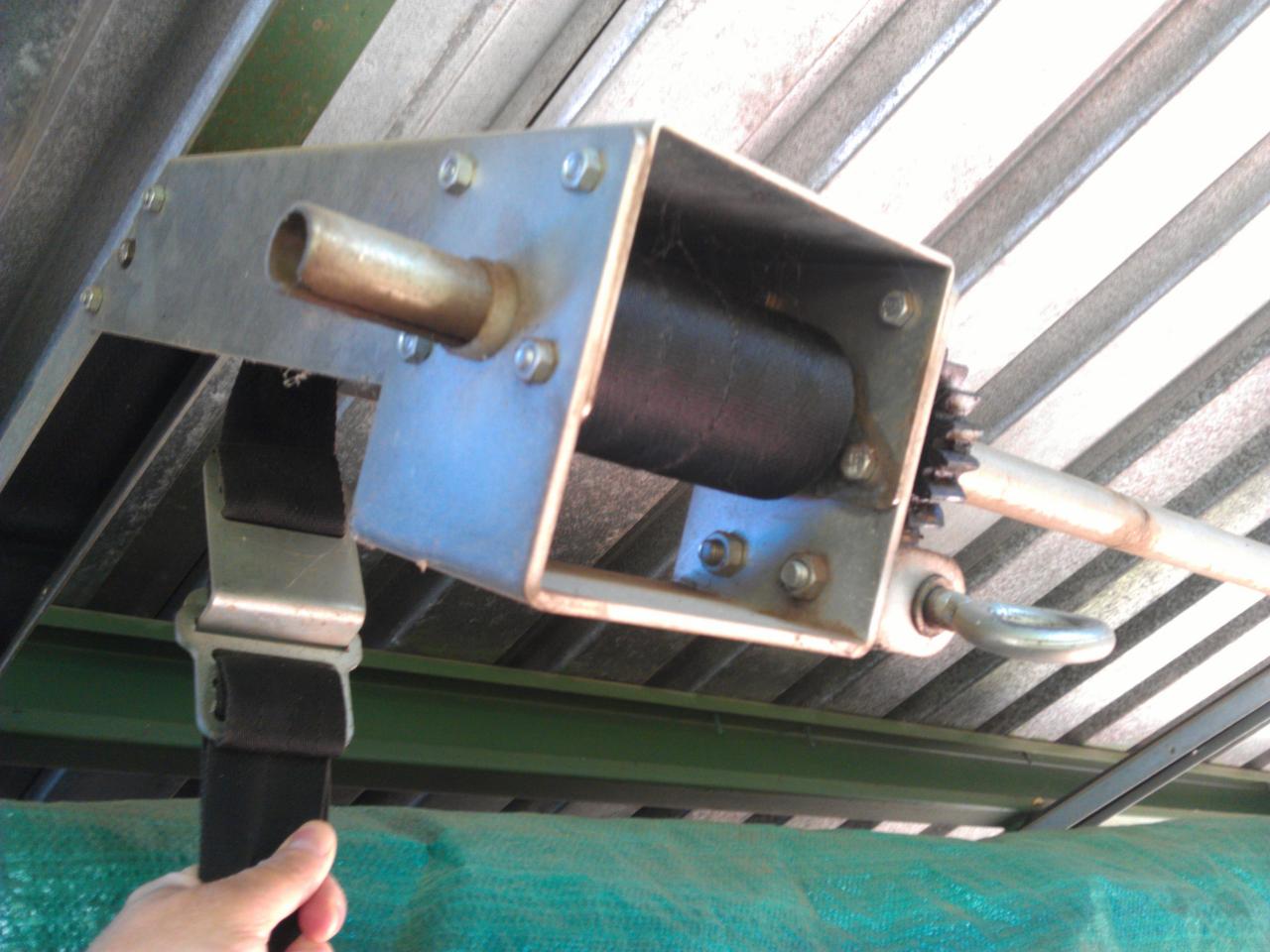 Front left - bottom showing shaft and belts for front &amp; rear