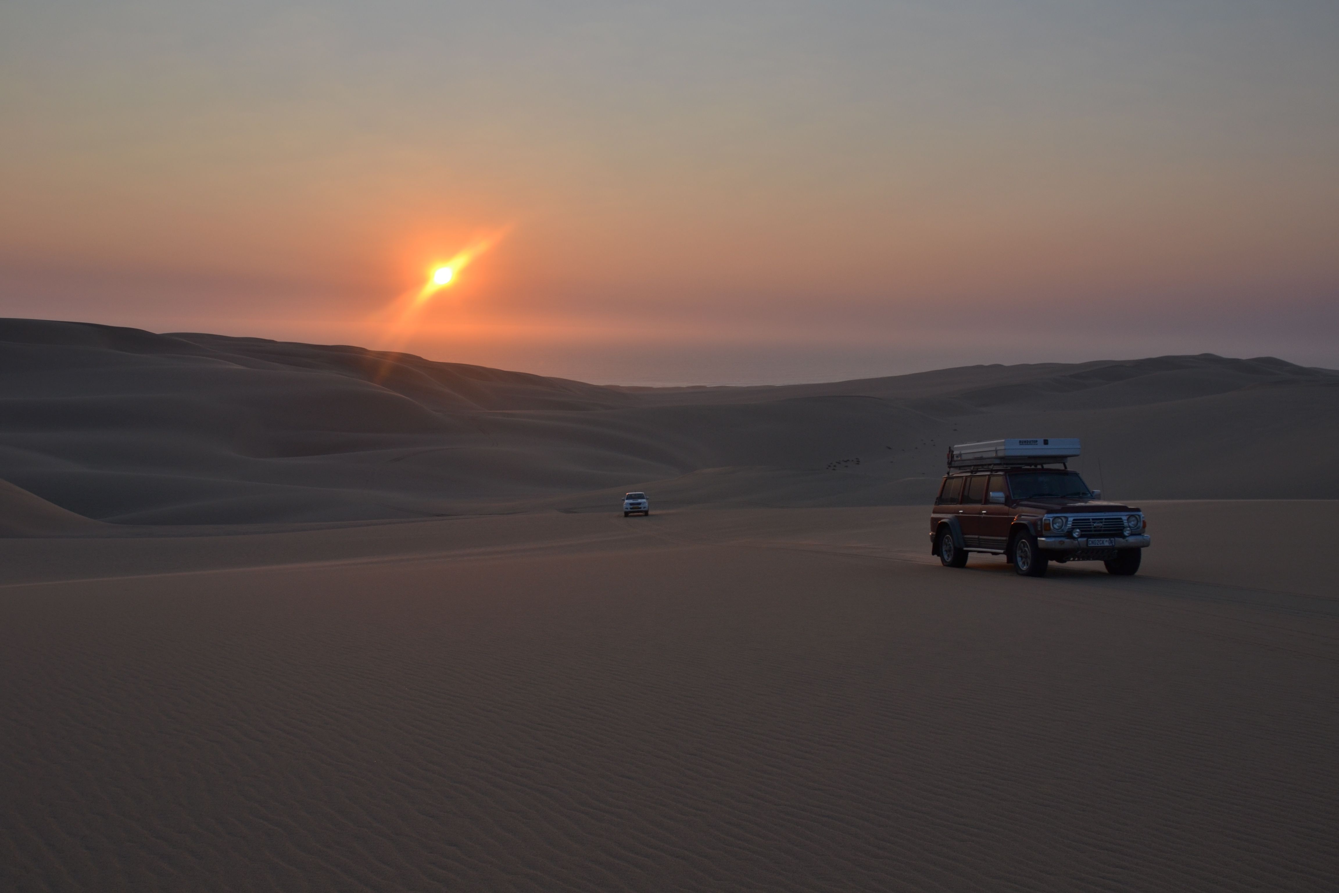 Patrol GQ in the NAMIB against a setting sun ..