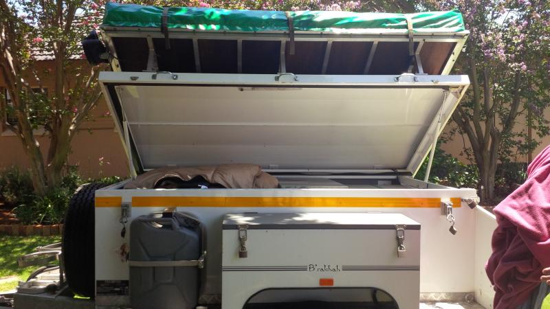 lifting the lid to get into the trailer